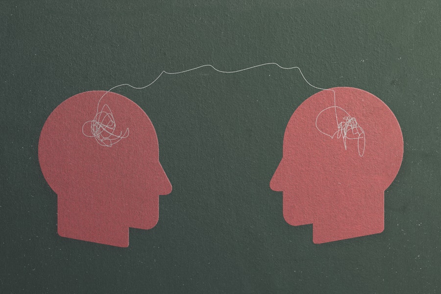 Two felt heads are connected by a string indicating empathy.